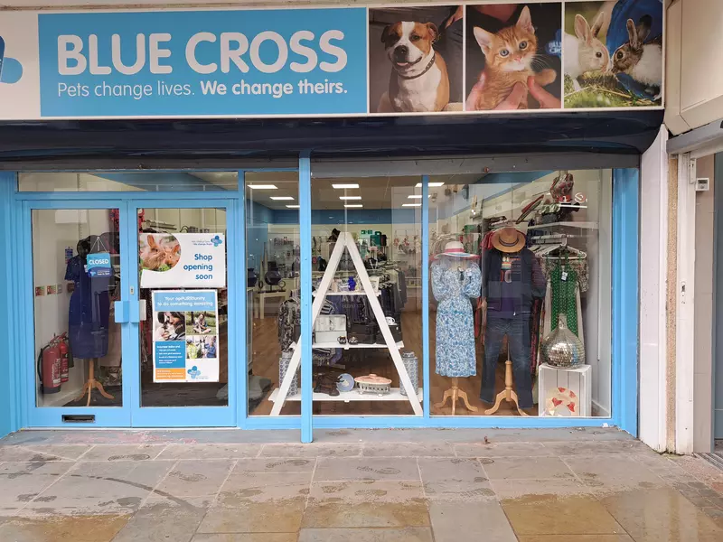 Dudley Blue Cross charity shop shop front with window displays and blue and white signage