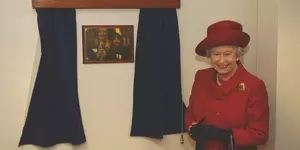 The Queen stands next to a gold plaque at the refurbished Victoria animal hospital in London